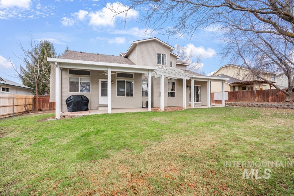 Rear view of house featuring a patio area, a ceiling fan, and a fenced backyard