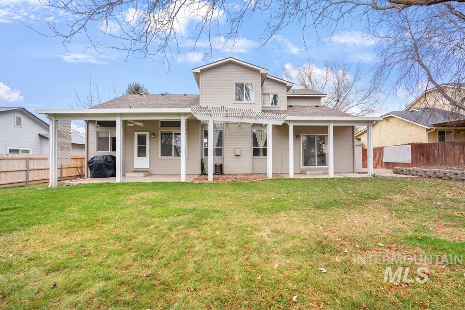Rear view of house with a patio area, a shingled roof, a fenced backyard, and ceiling fan
