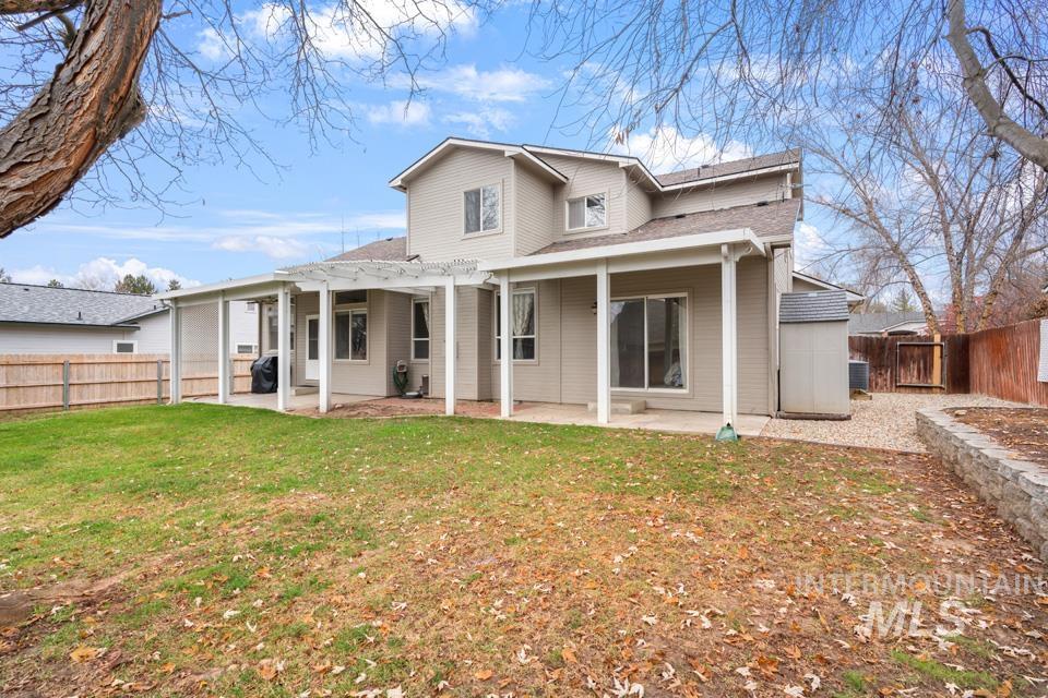 Rear view of house with a patio area and a fenced backyard