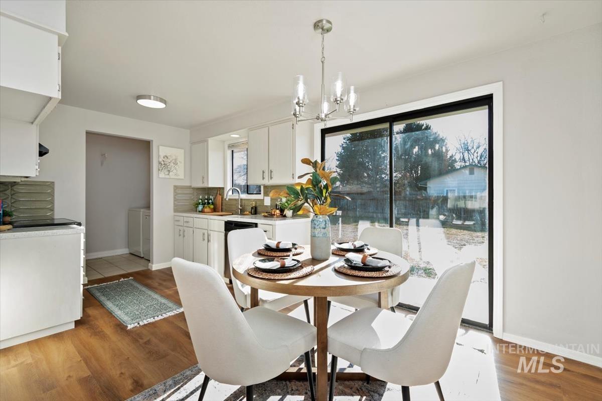 Dining space featuring a chandelier and light wood-style flooring