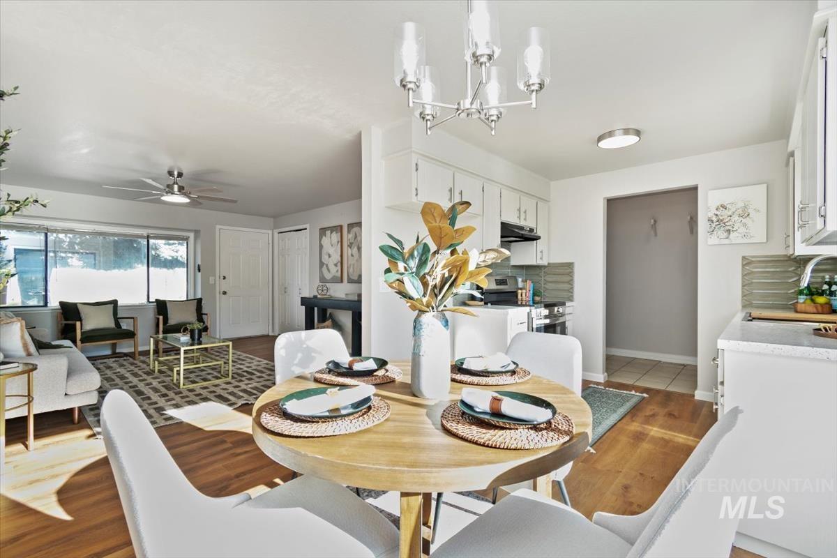 Dining area with a ceiling fan and light wood-style flooring