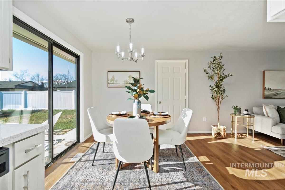 Dining space featuring a chandelier and wood finished floors