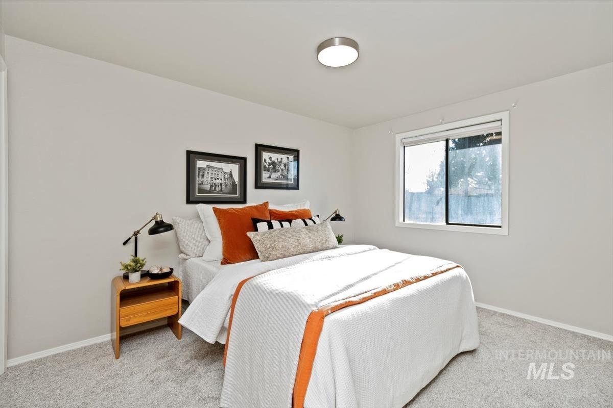 Carpeted bedroom featuring baseboards