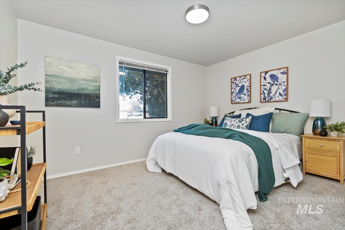 Carpeted bedroom with baseboards