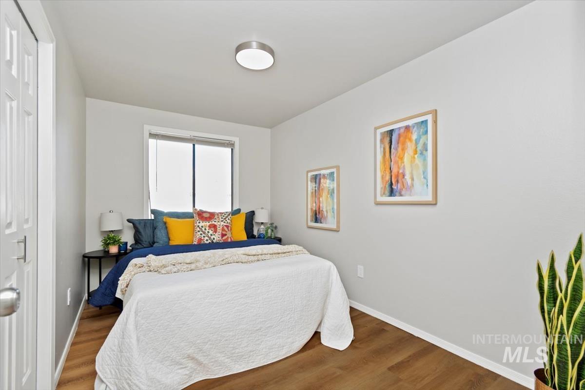 Bedroom featuring wood finished floors and a closet