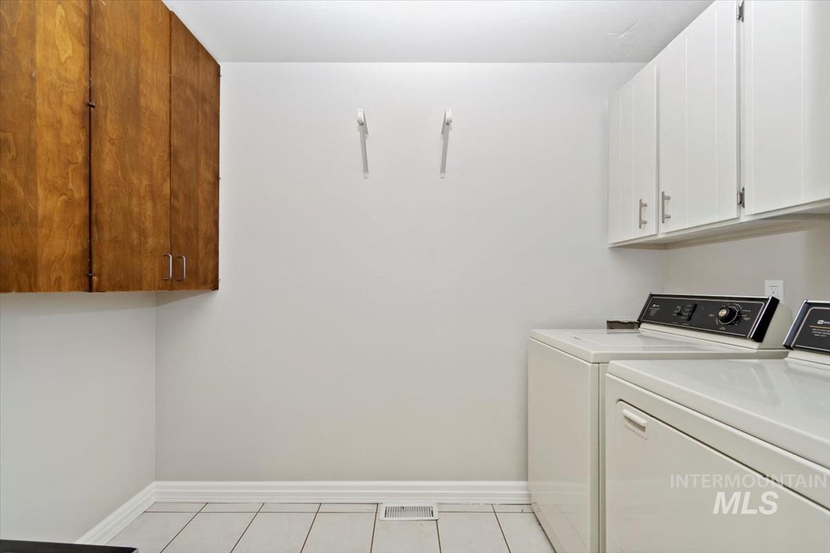 Laundry area with cabinet space and washer and dryer