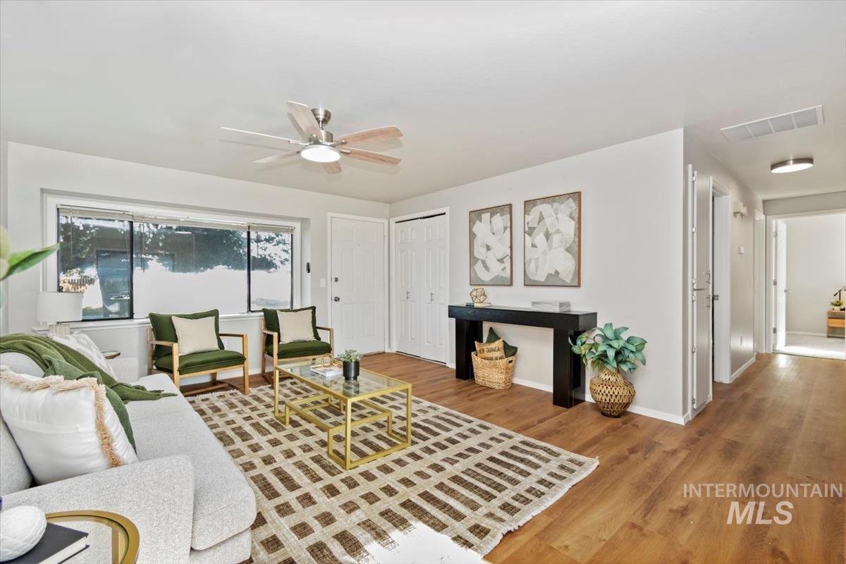Living room with ceiling fan and wood finished floors