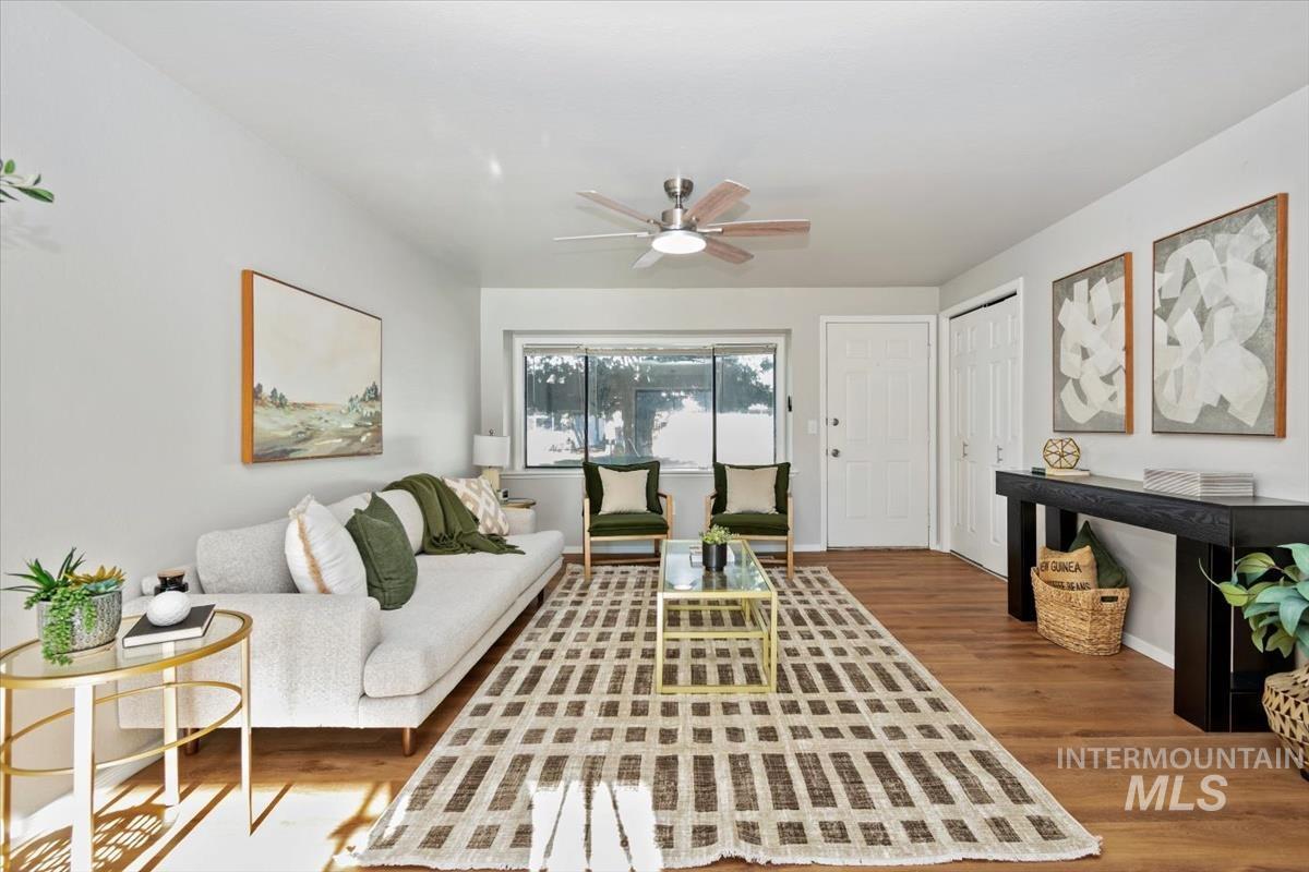 Living area with wood finished floors and a ceiling fan