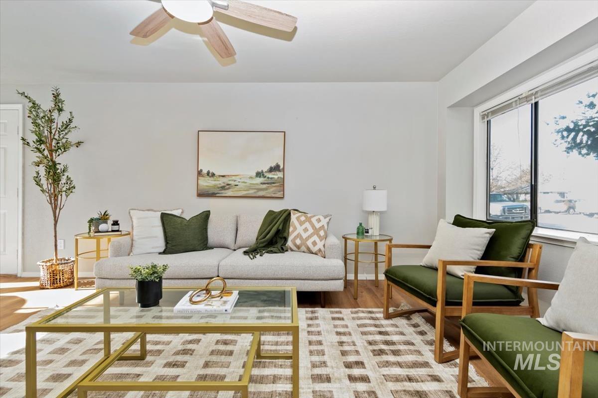 Living area featuring ceiling fan and wood finished floors
