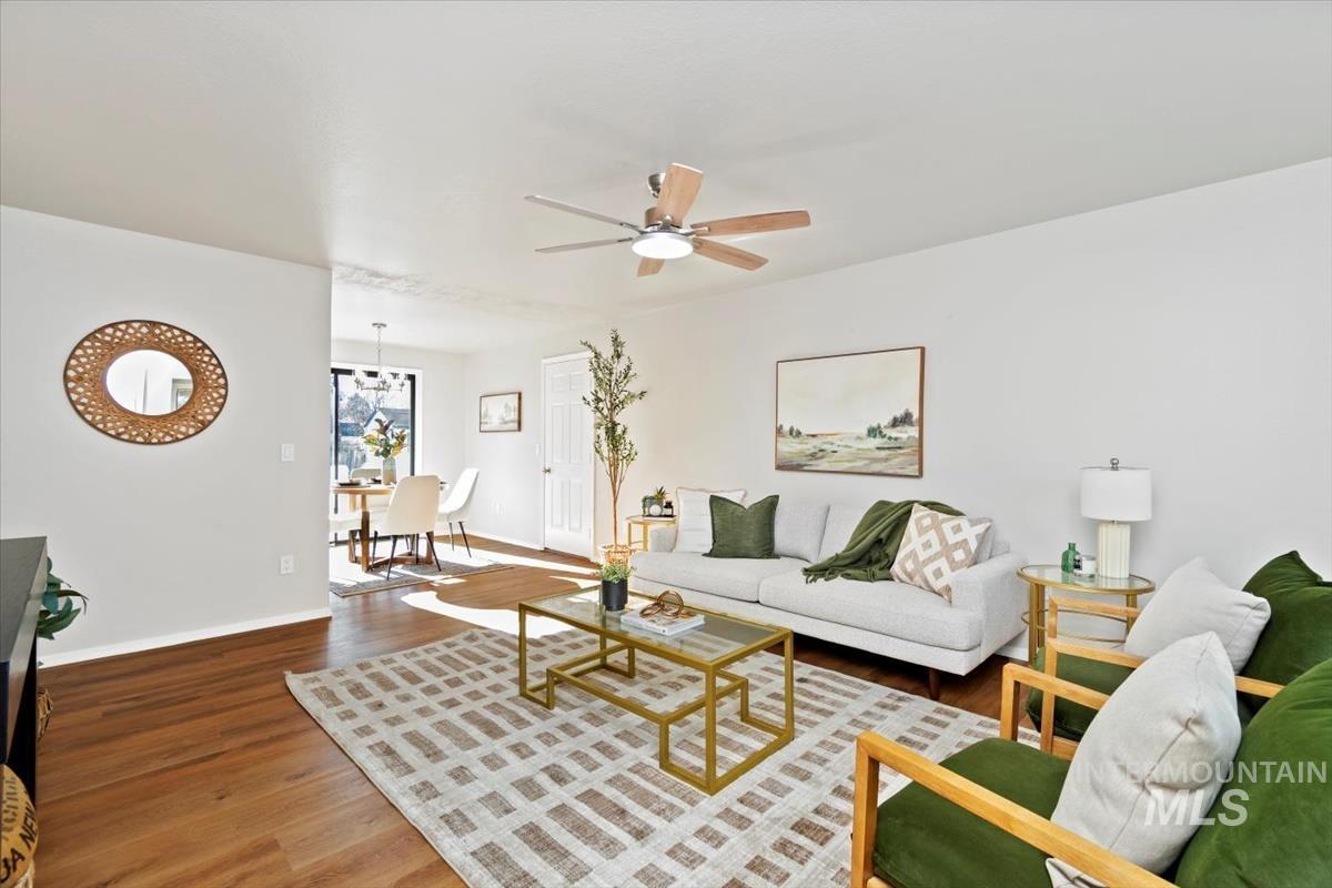 Living area with wood finished floors and a ceiling fan