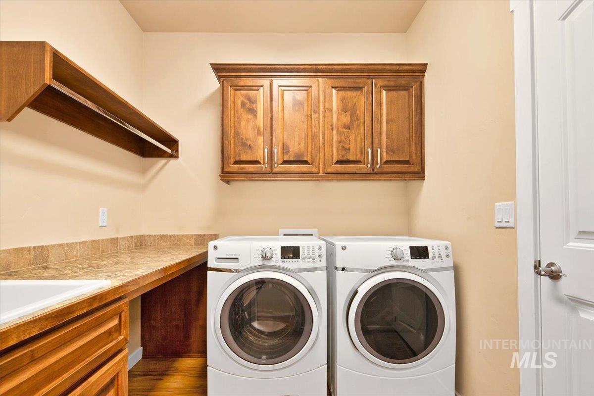Laundry area with independent washer and dryer and cabinet space
