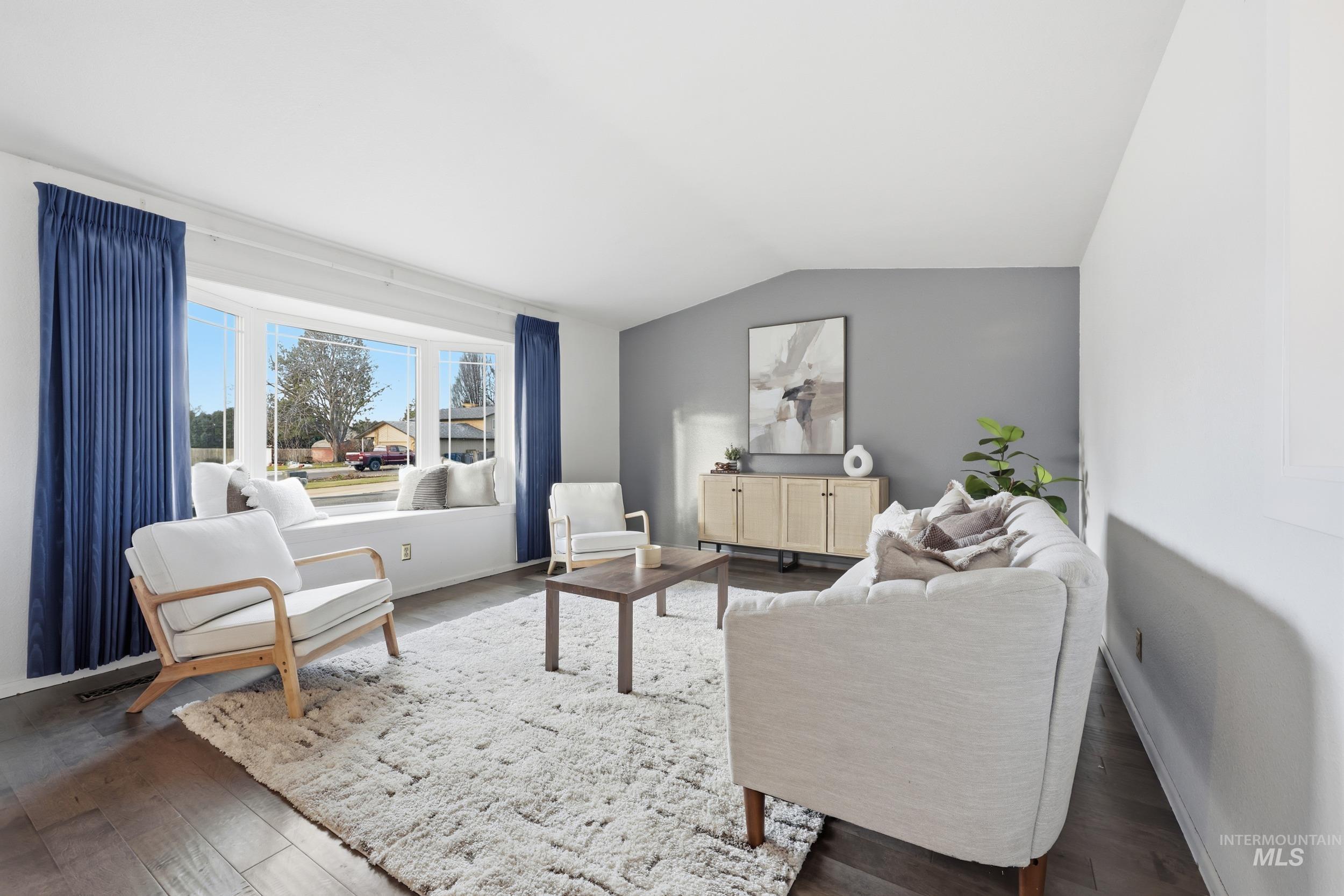 Living room with lofted ceiling and new engineered hardwood floors.
