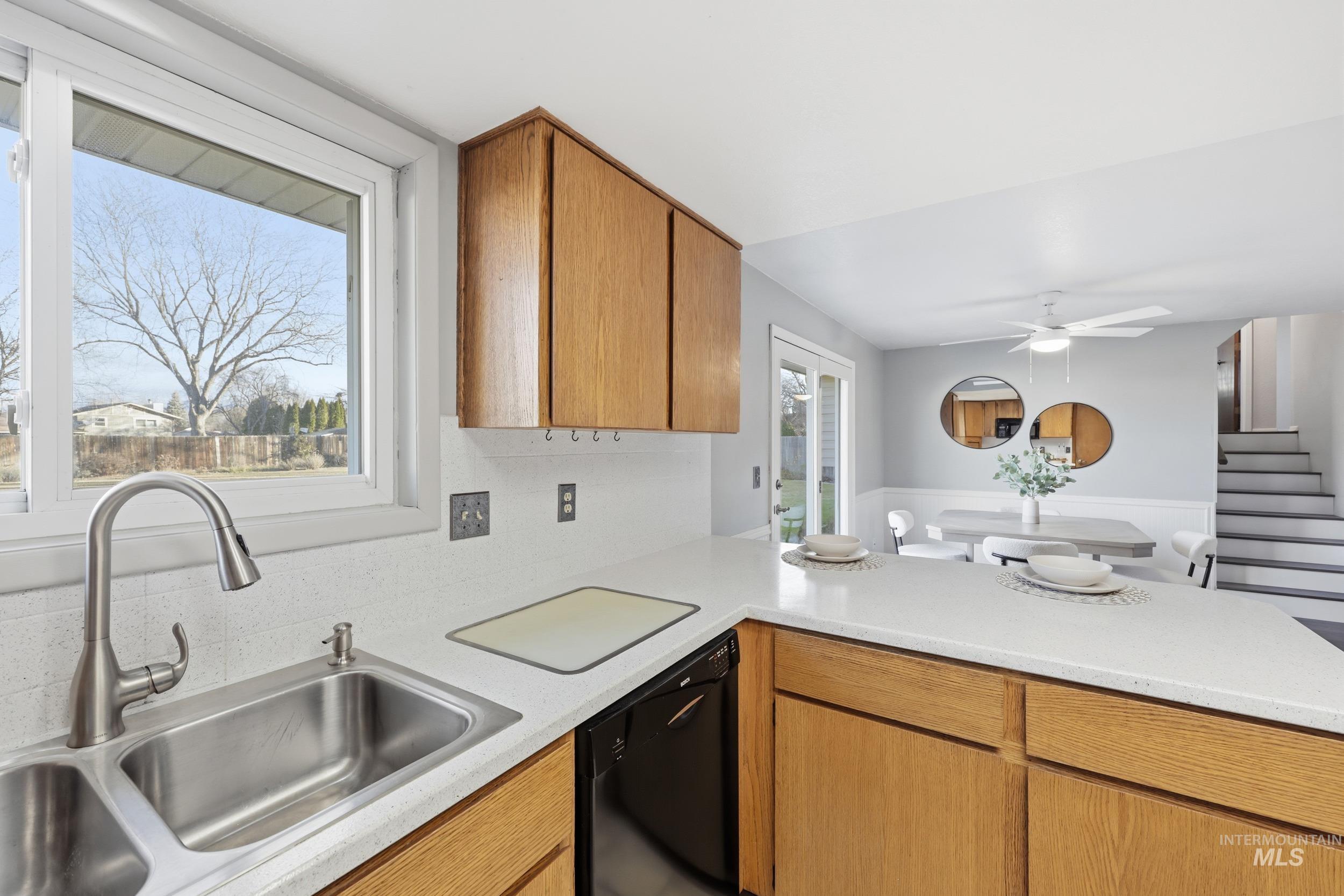 Kitchen with a peninsula and light hardsurface counters.