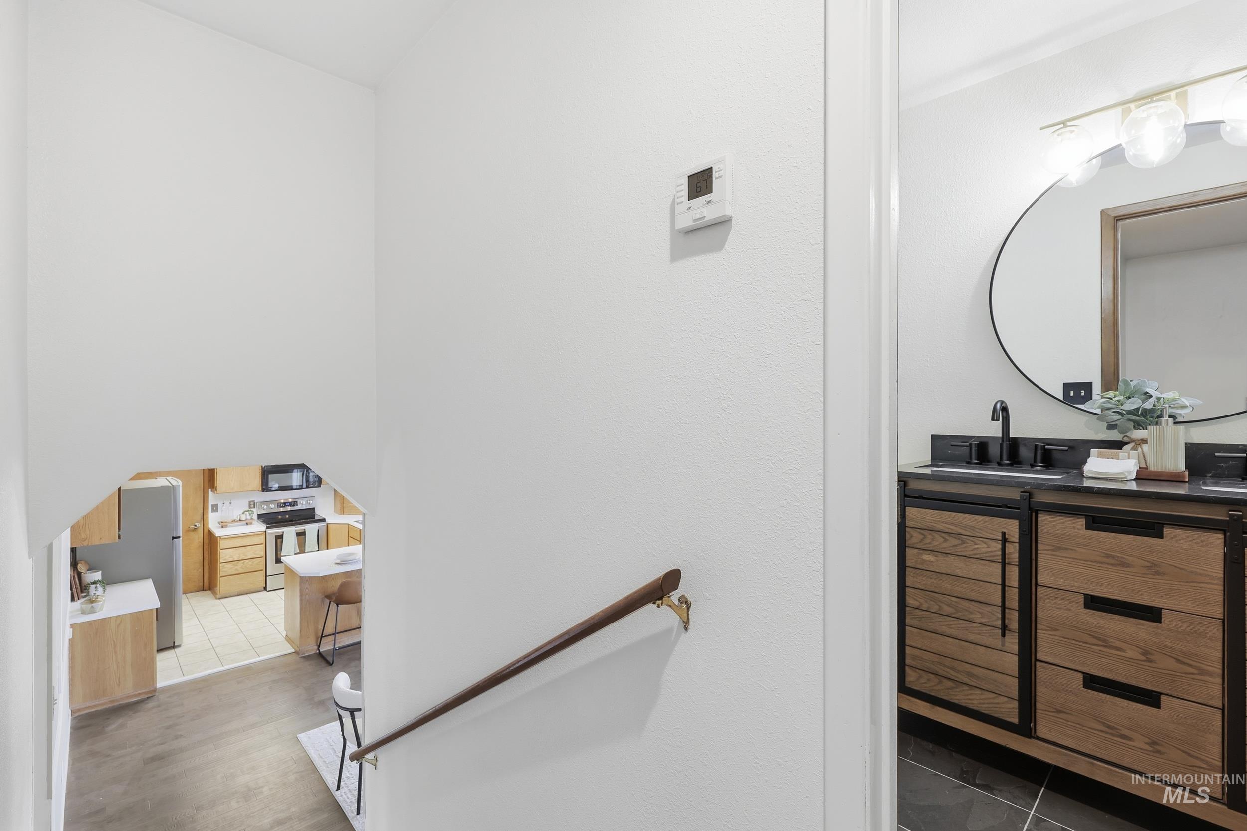 Bathroom with an updated vanity and tile floors.
