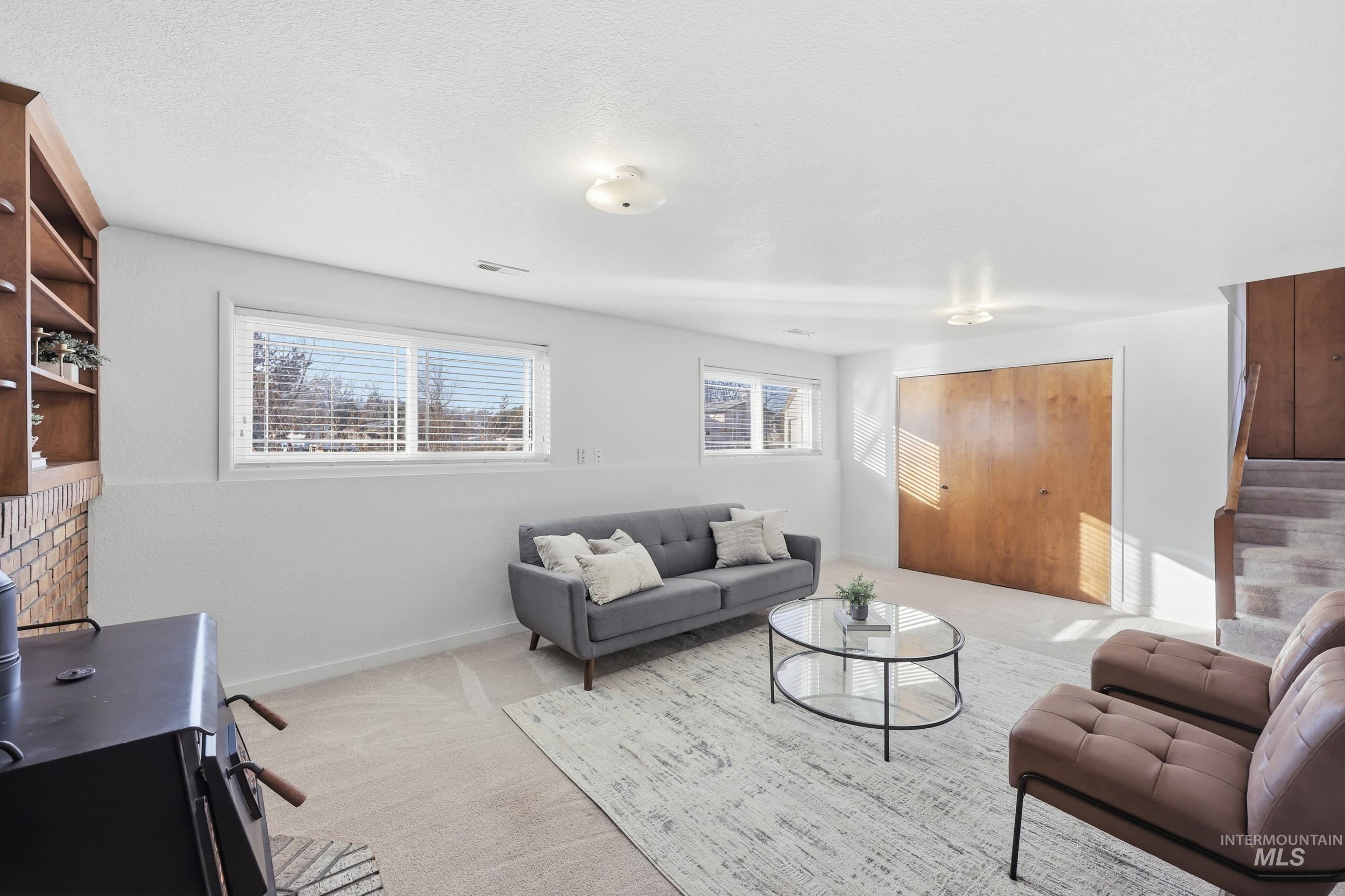 Family room with new carpet and a wood stove.