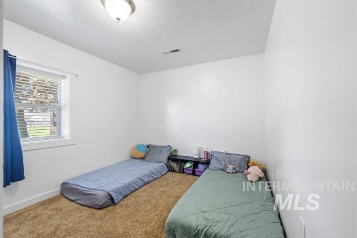 Bedroom with carpet and baseboards