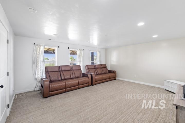 Living room with plenty of natural light, light carpet, and recessed lighting