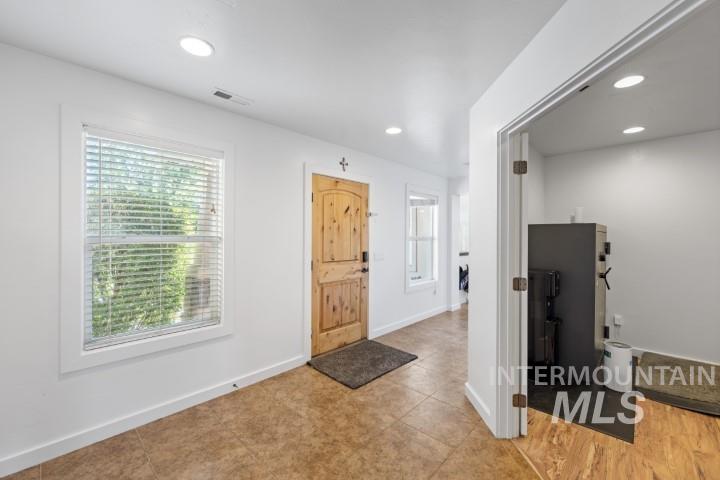 Entrance foyer with plenty of natural light and recessed lighting