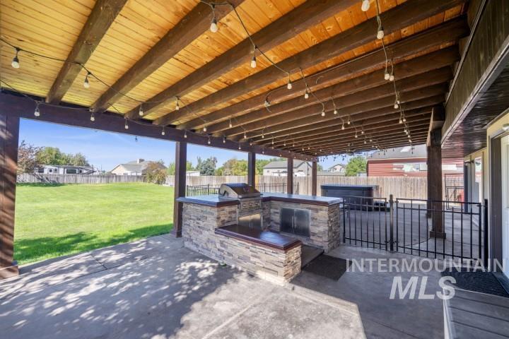 Fenced backyard with a patio area and area for grilling