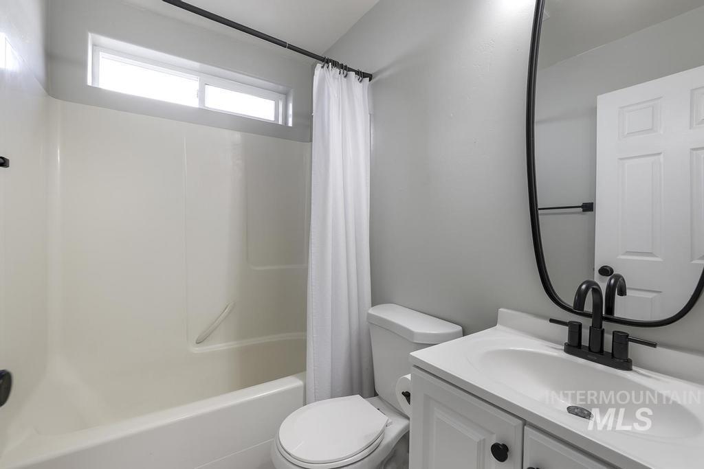 Full bathroom featuring vanity and shower / bath combo with shower curtain