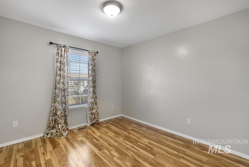 Empty room featuring light wood-style flooring and baseboards