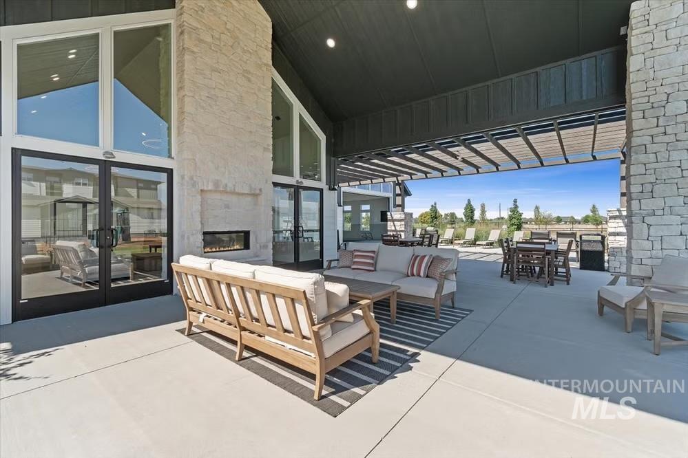 View of patio / terrace with french doors, outdoor lounge area, outdoor dining space, and a pergola