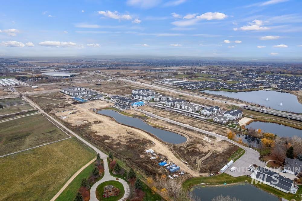 Aerial view of property and surrounding area with a nearby body of water