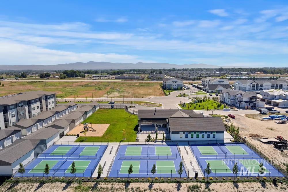 Aerial view of residential area featuring mountains