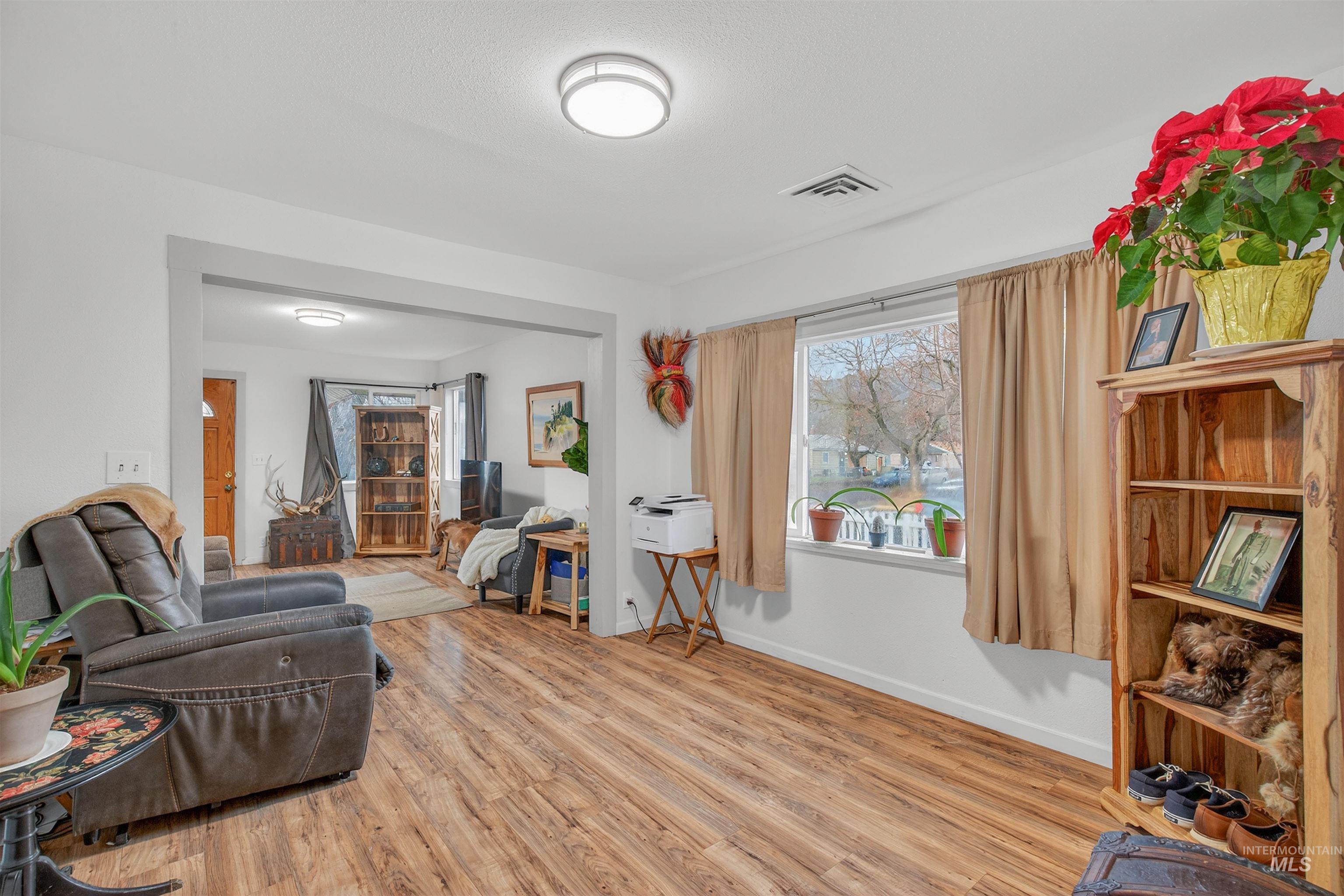 Living area featuring light wood finished floors and baseboards