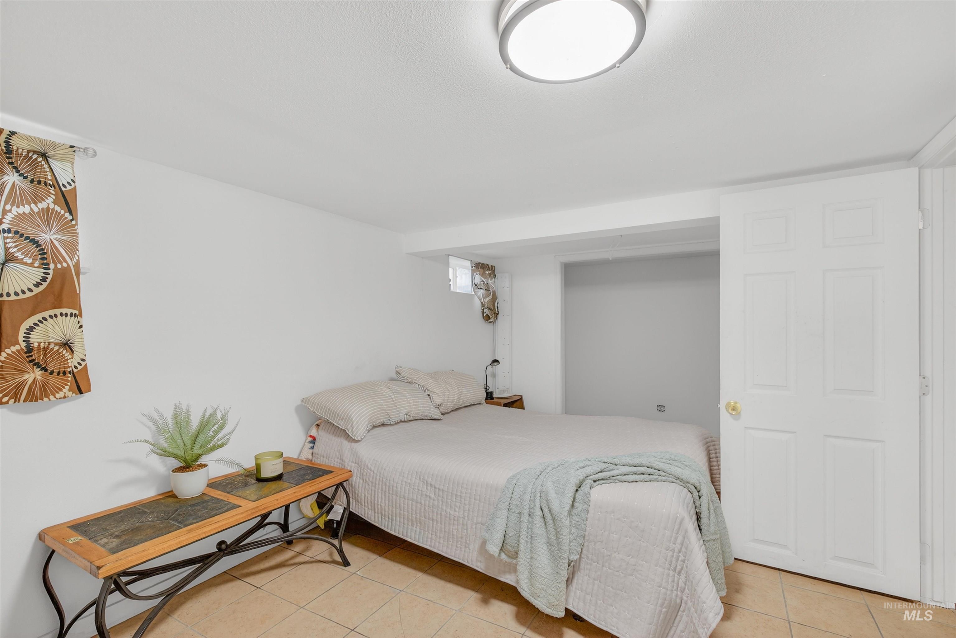 Bedroom featuring light tile patterned floors