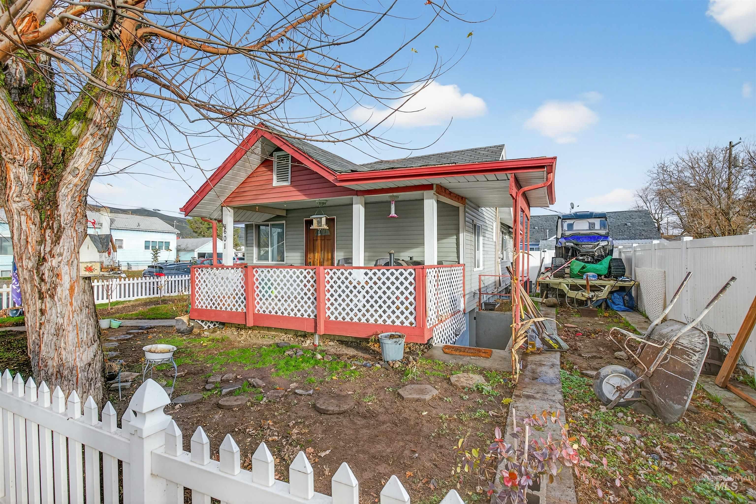 Shotgun-style home with a shingled roof