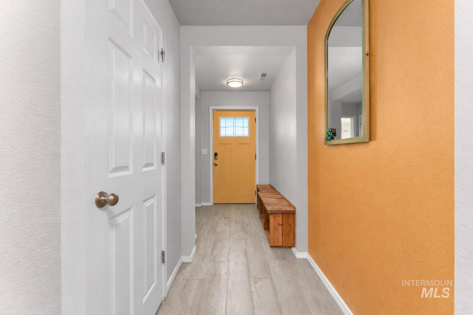 Entryway with baseboards and wood finished floors