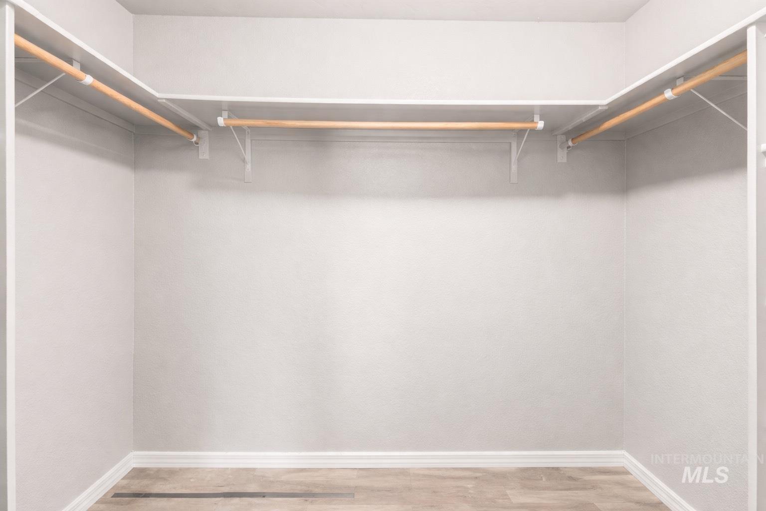 Spacious closet featuring light wood-style floors