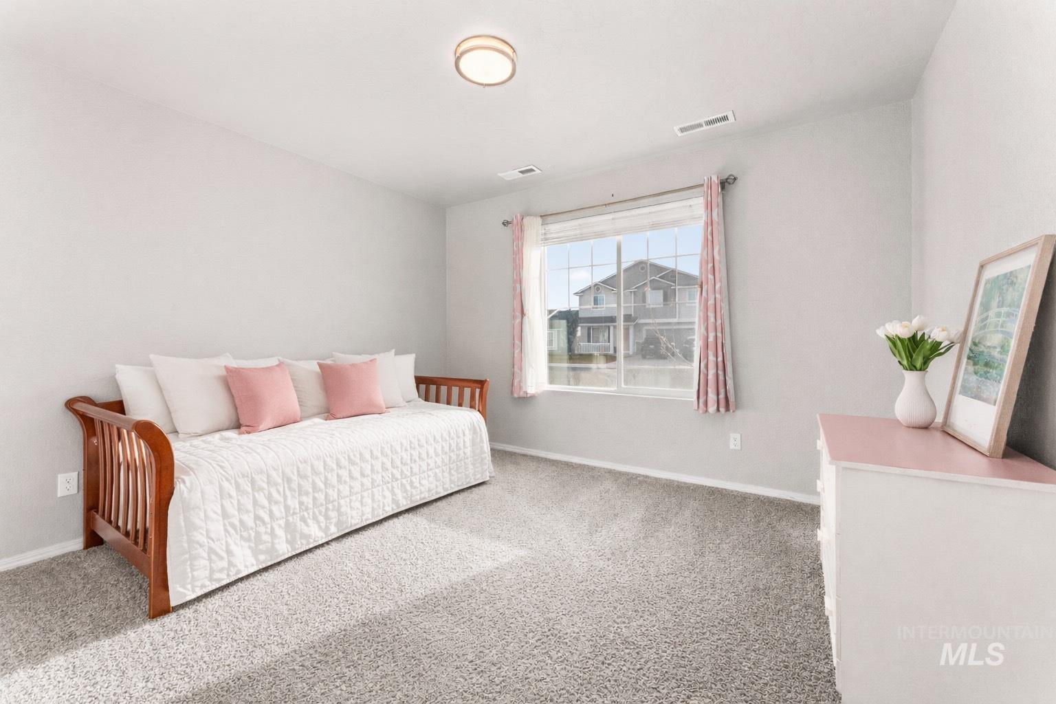 Carpeted bedroom with baseboards