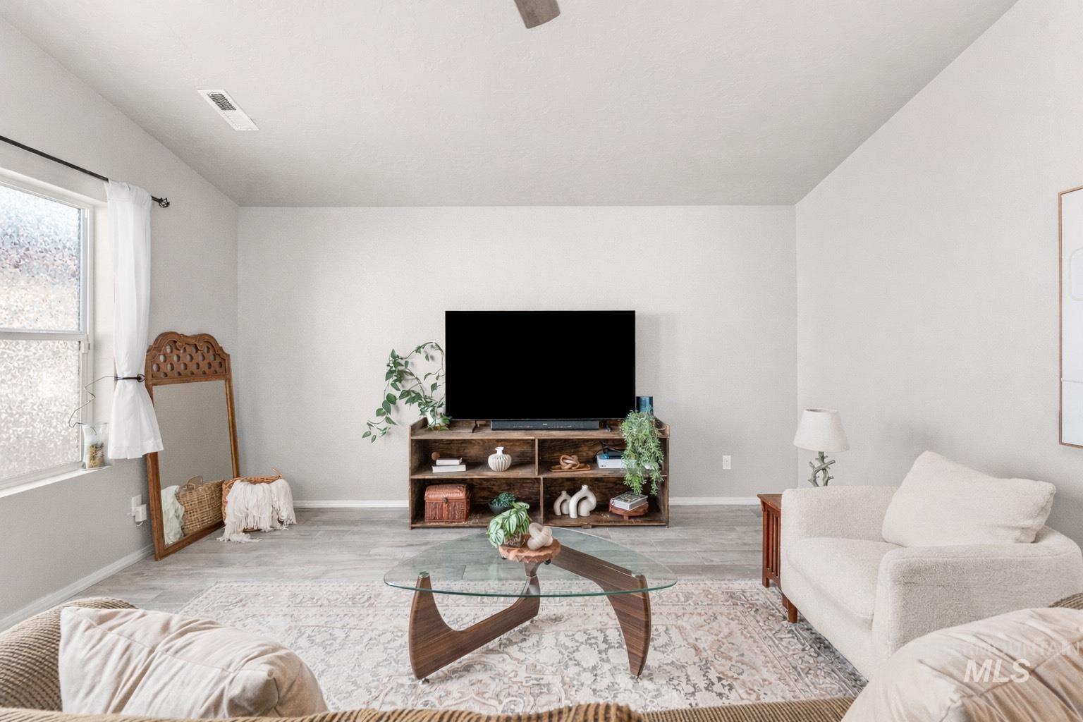 Living room with wood finished floors and lofted ceiling