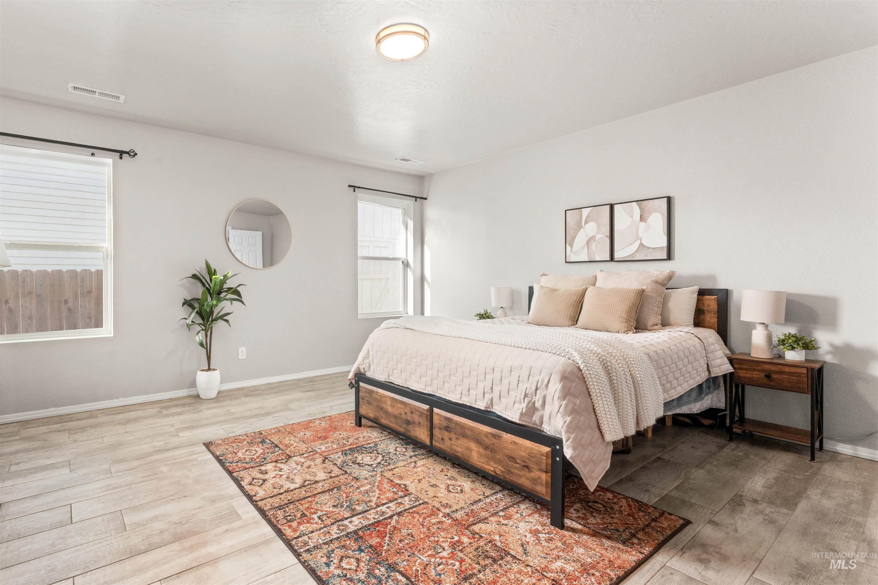 Bedroom with light wood-style floors and baseboards