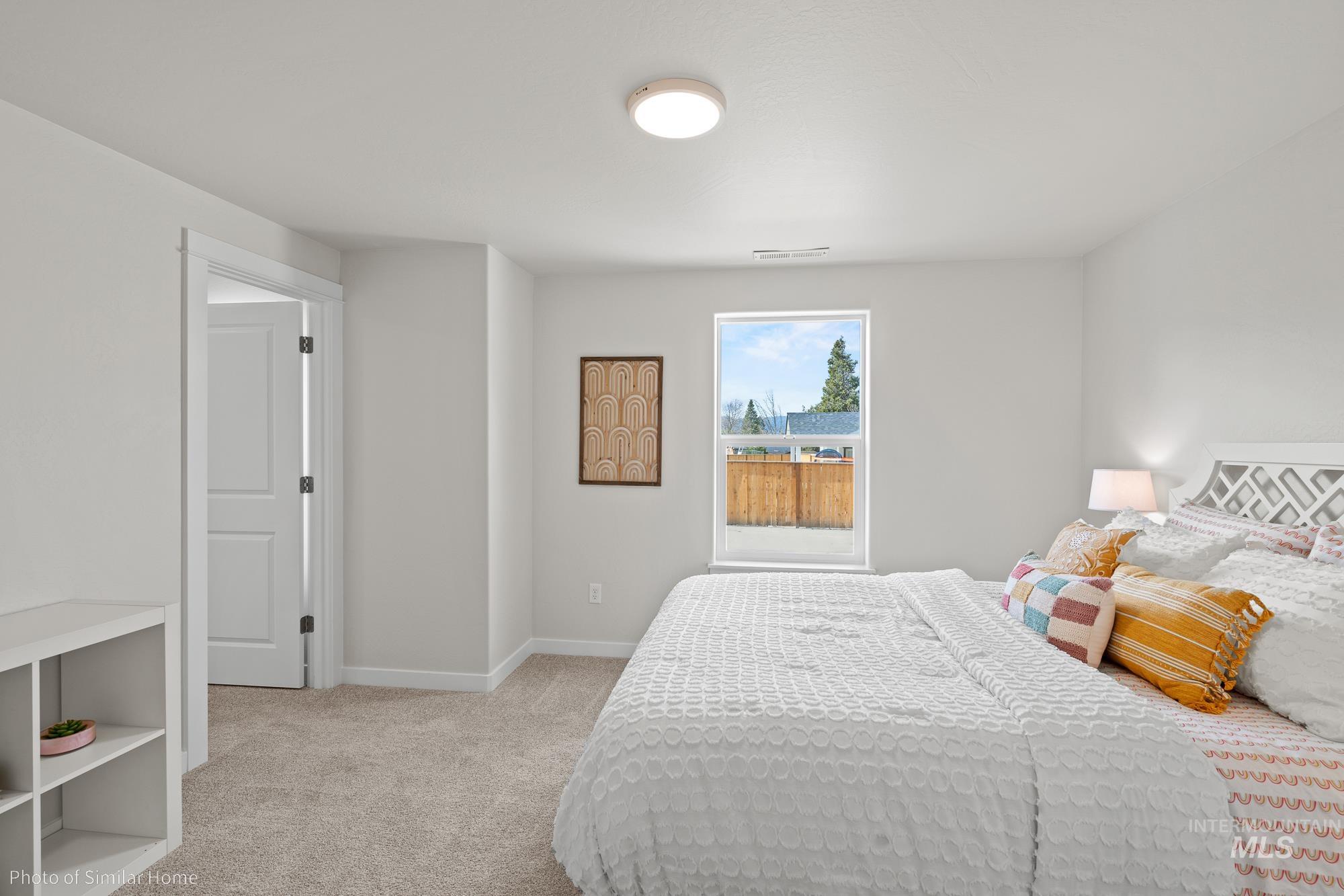 Carpeted bedroom featuring baseboards