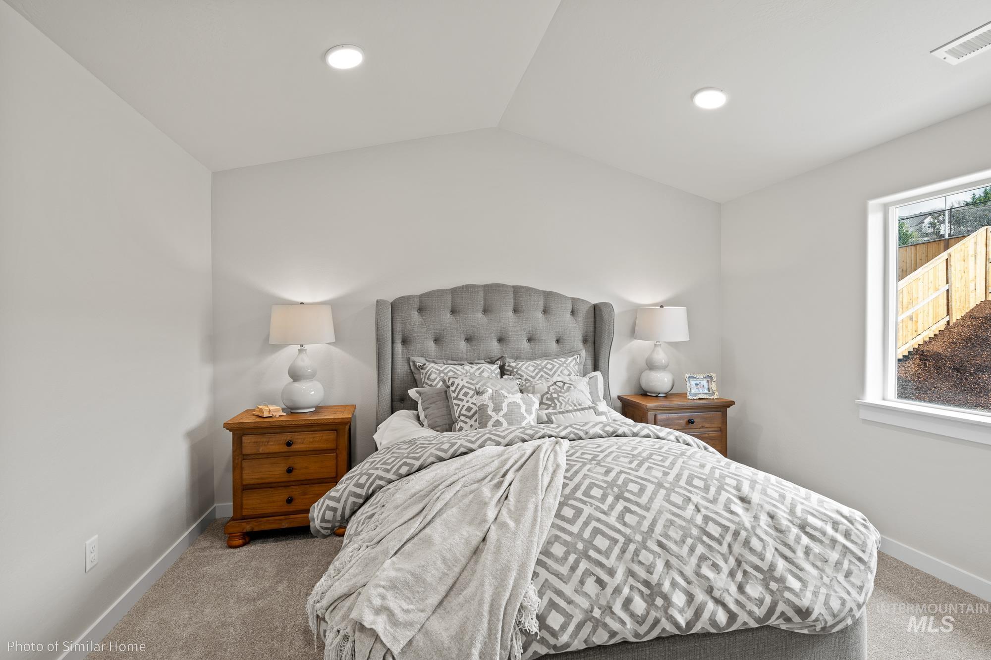 Bedroom with carpet flooring, vaulted ceiling, and recessed lighting