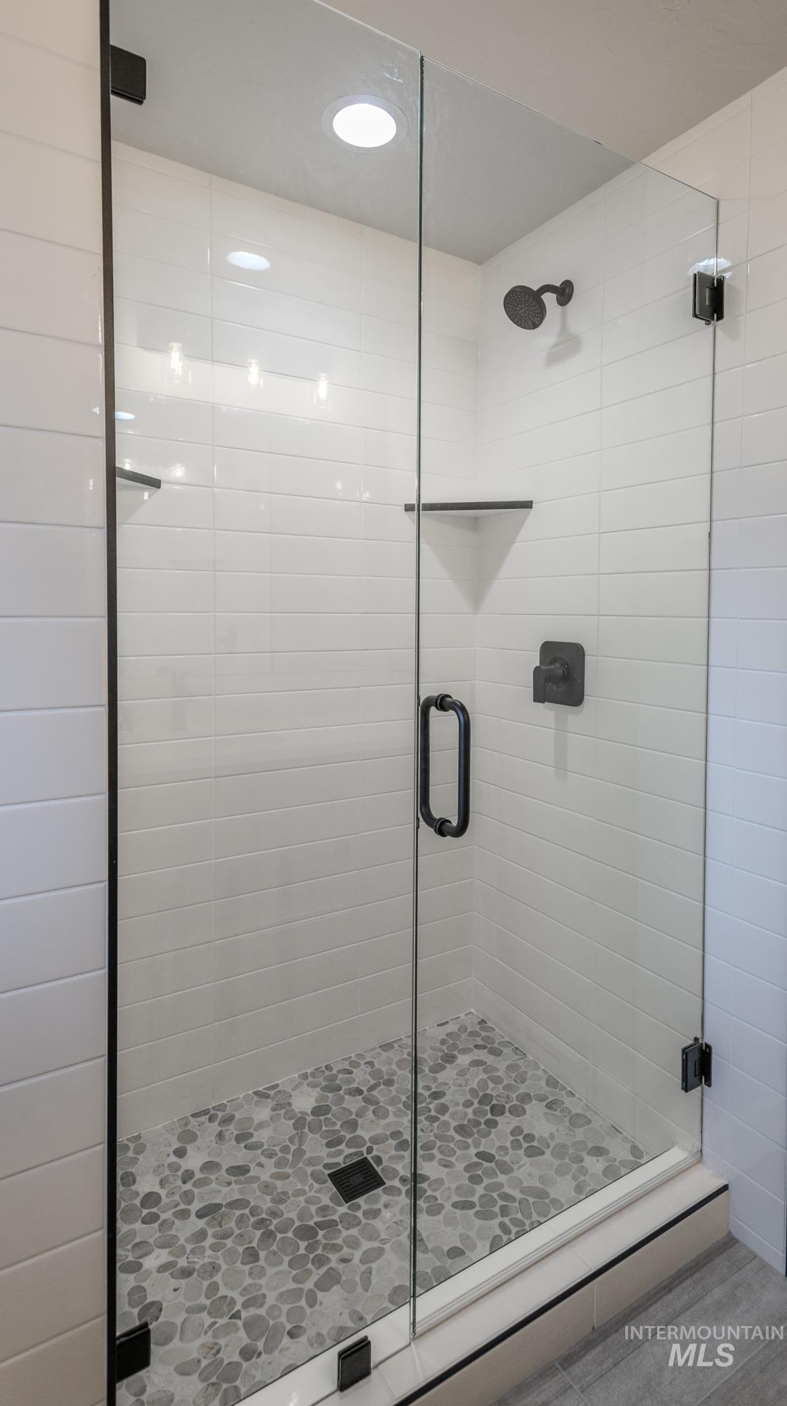 Bathroom 2 of 4.5 featuring a tiled stall shower and recessed lighting
