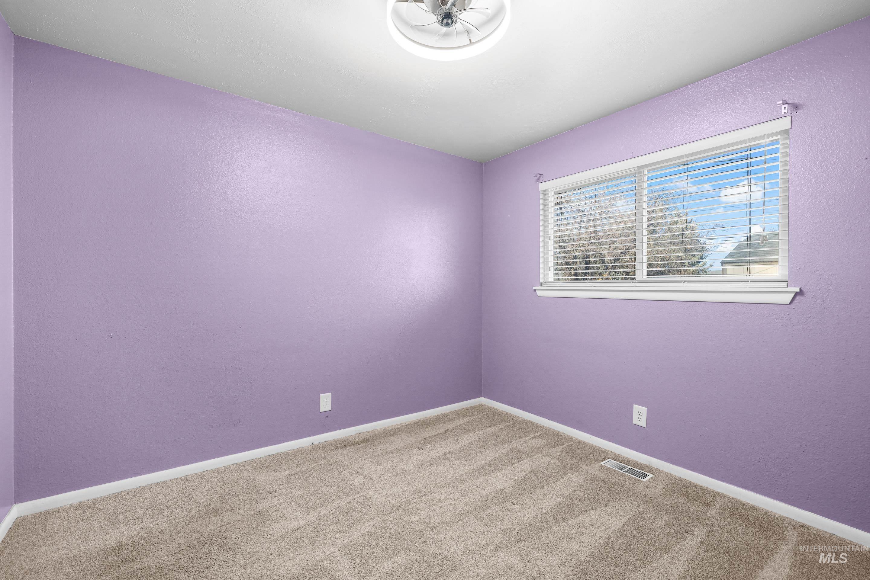 Spare room with carpet flooring and a textured wall