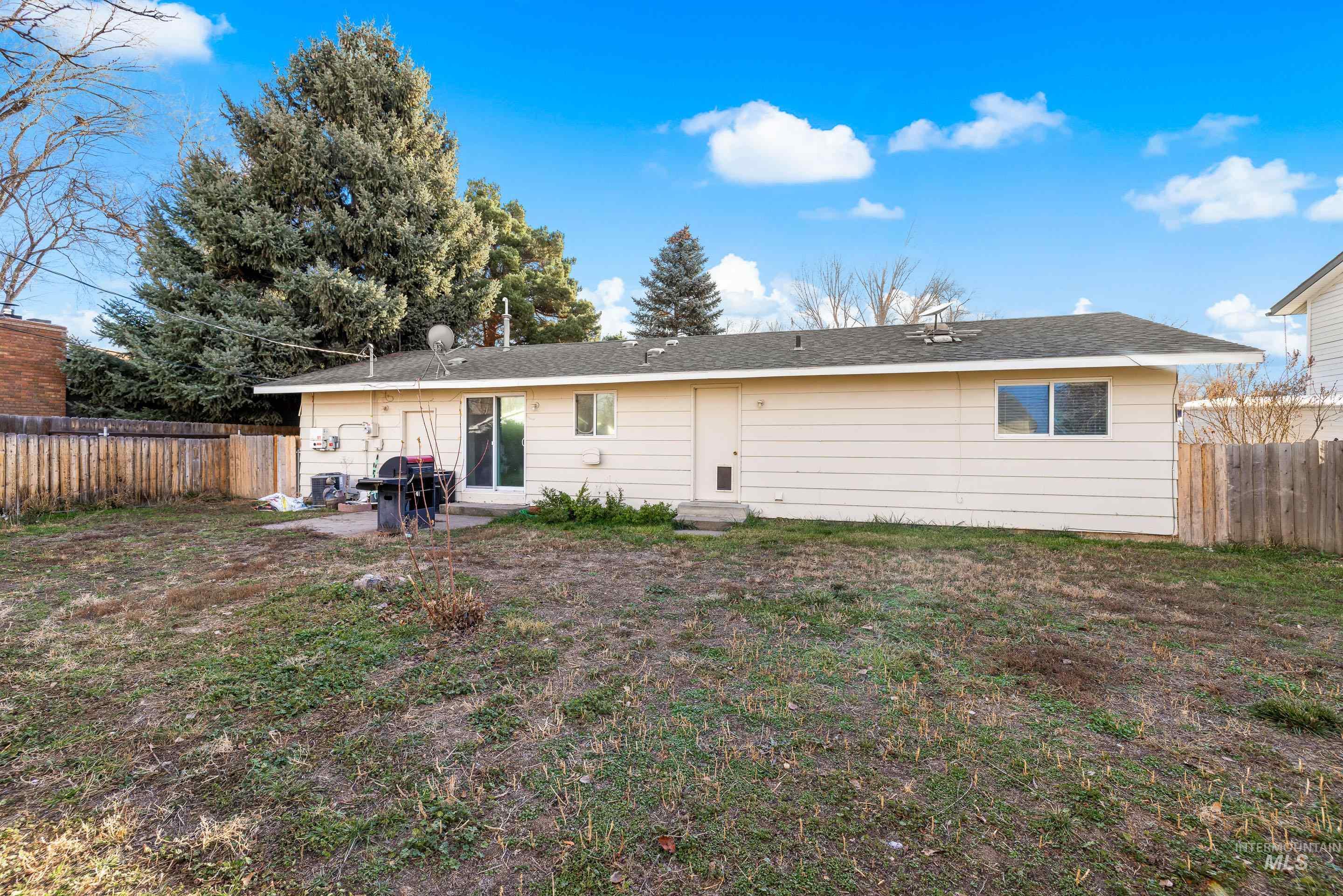 Back of property featuring a fenced backyard and a patio