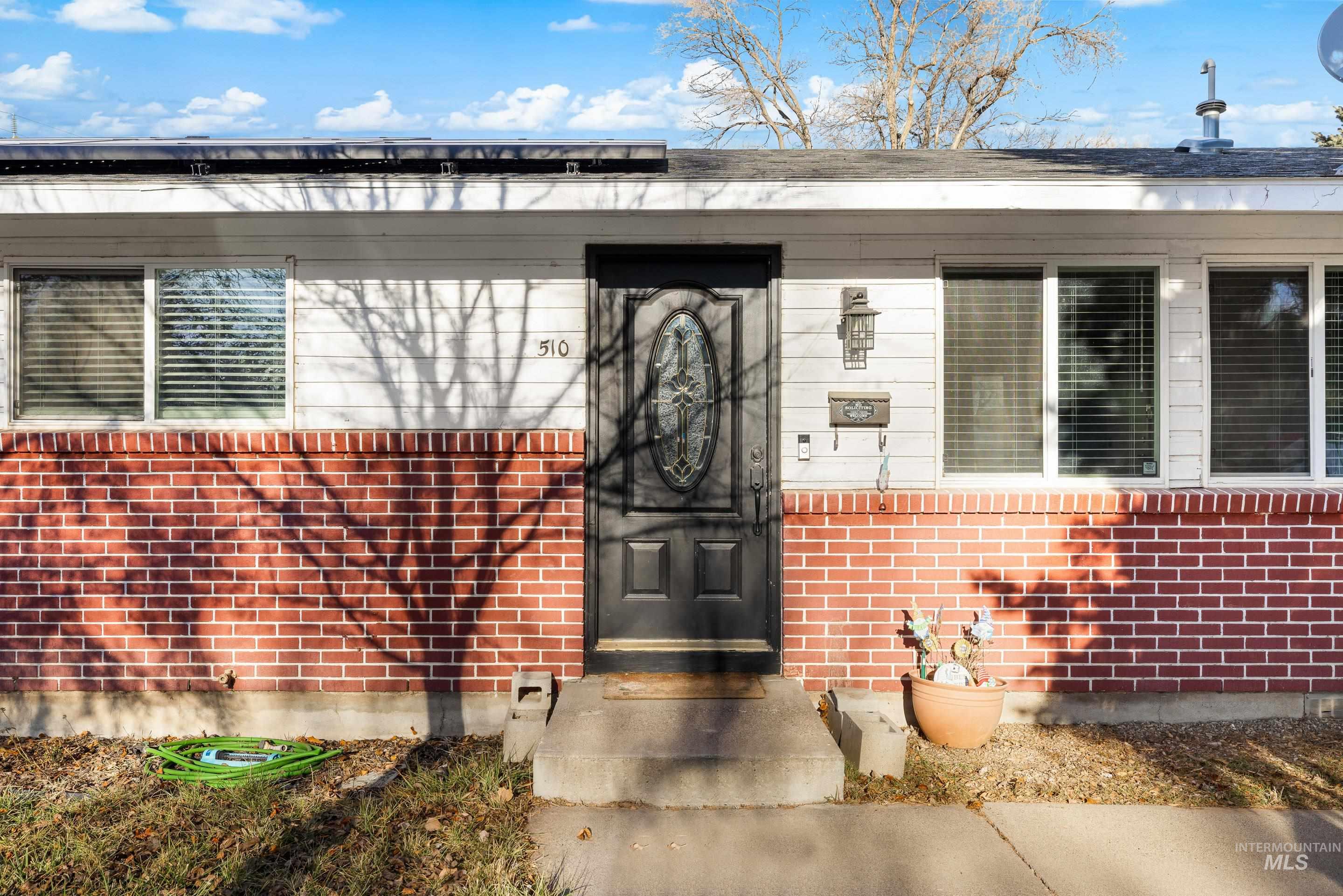 Entrance to property with brick siding