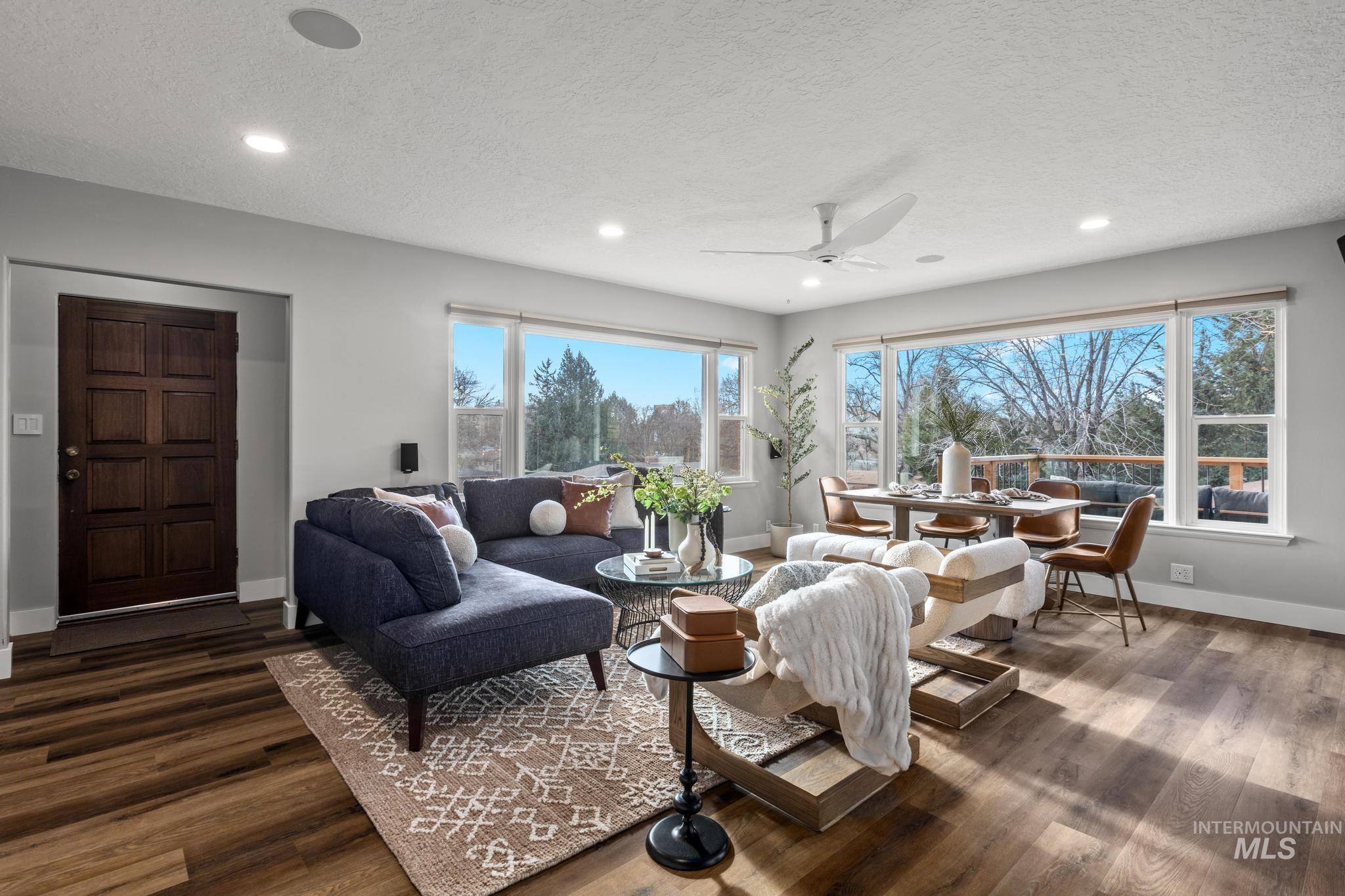Living room with a textured ceiling, dark wood-style floors, a ceiling fan, and recessed lighting