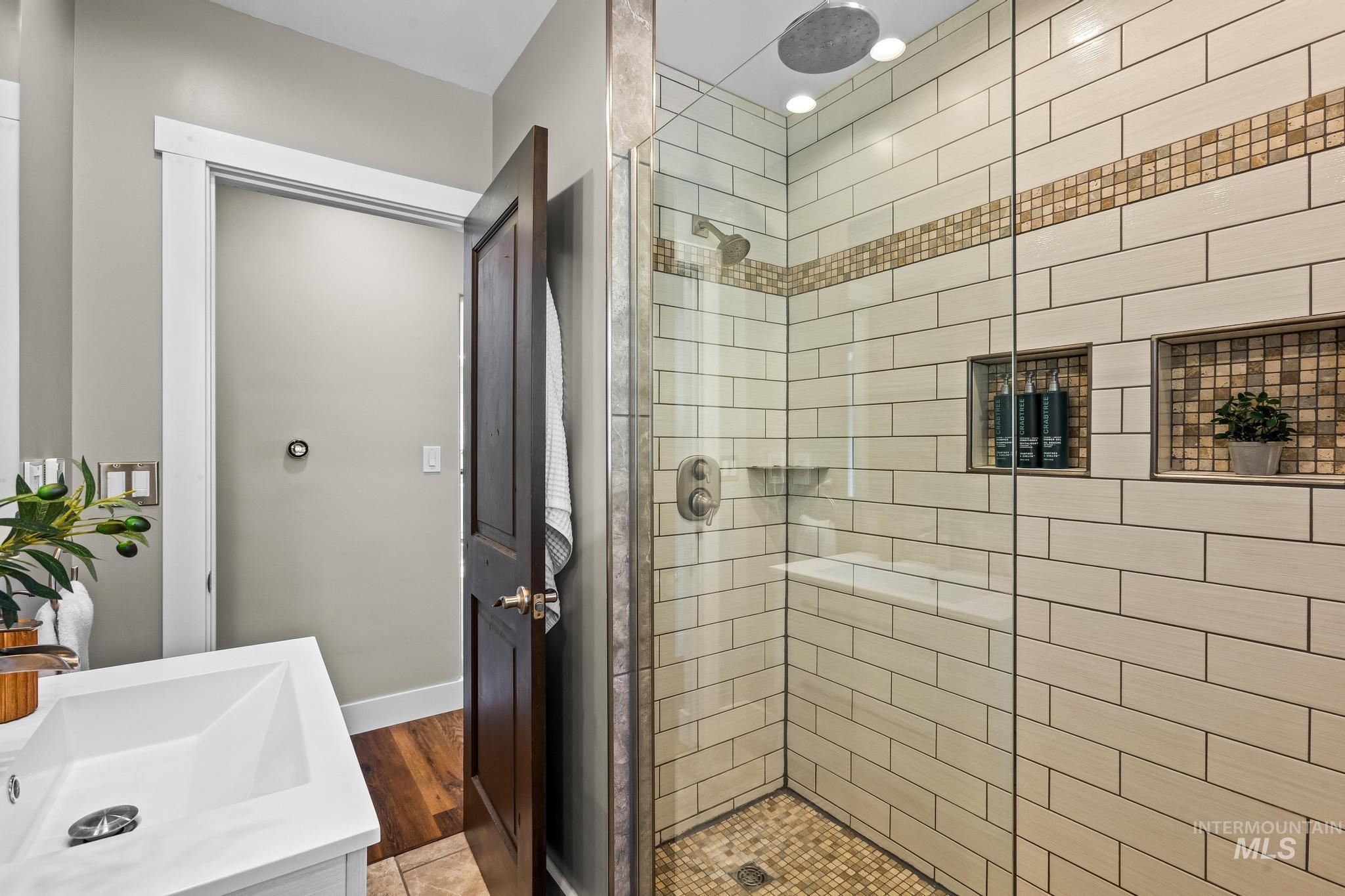 Bathroom featuring vanity and a shower stall