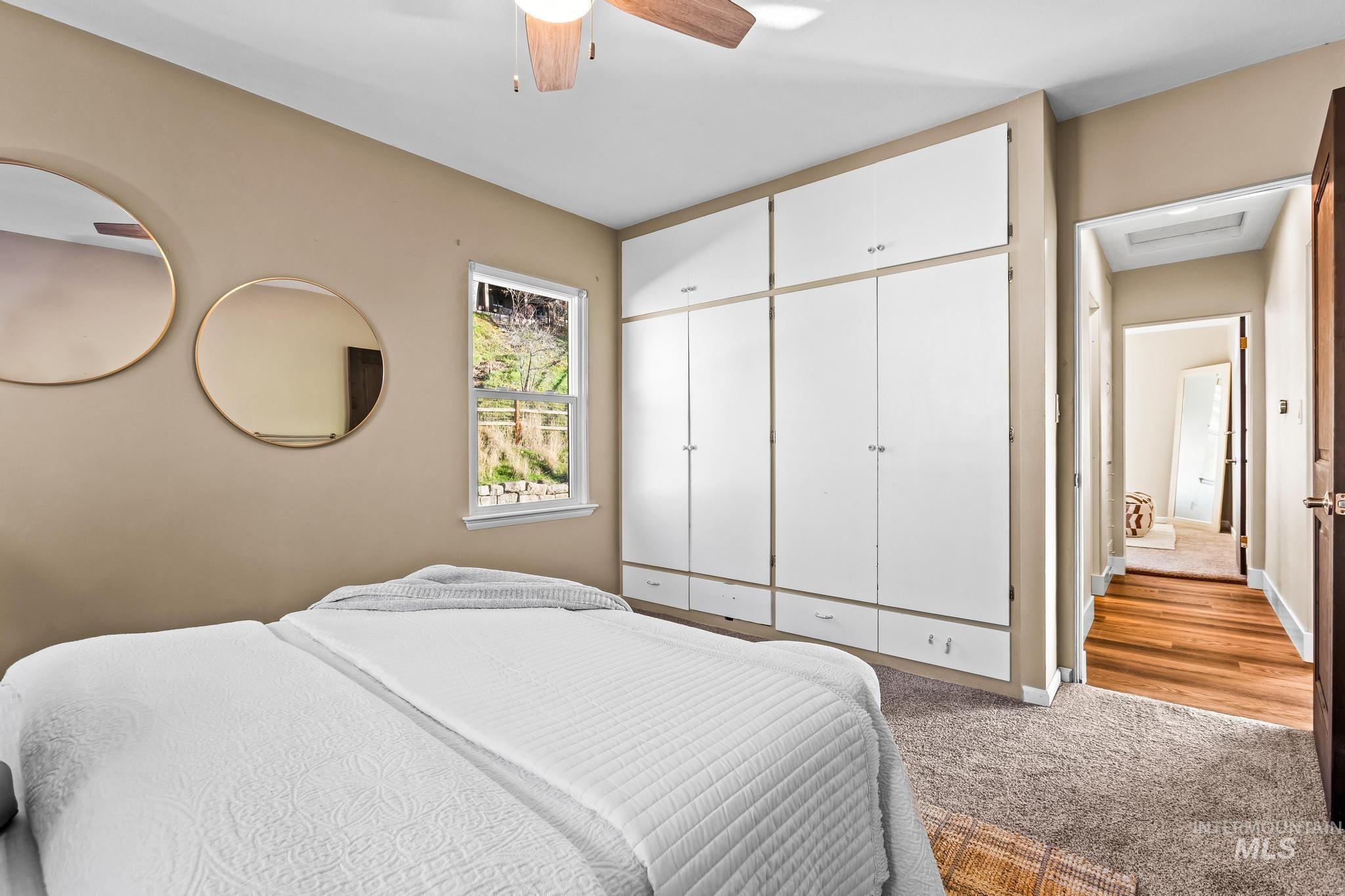 Bedroom featuring light colored carpet and ceiling fan