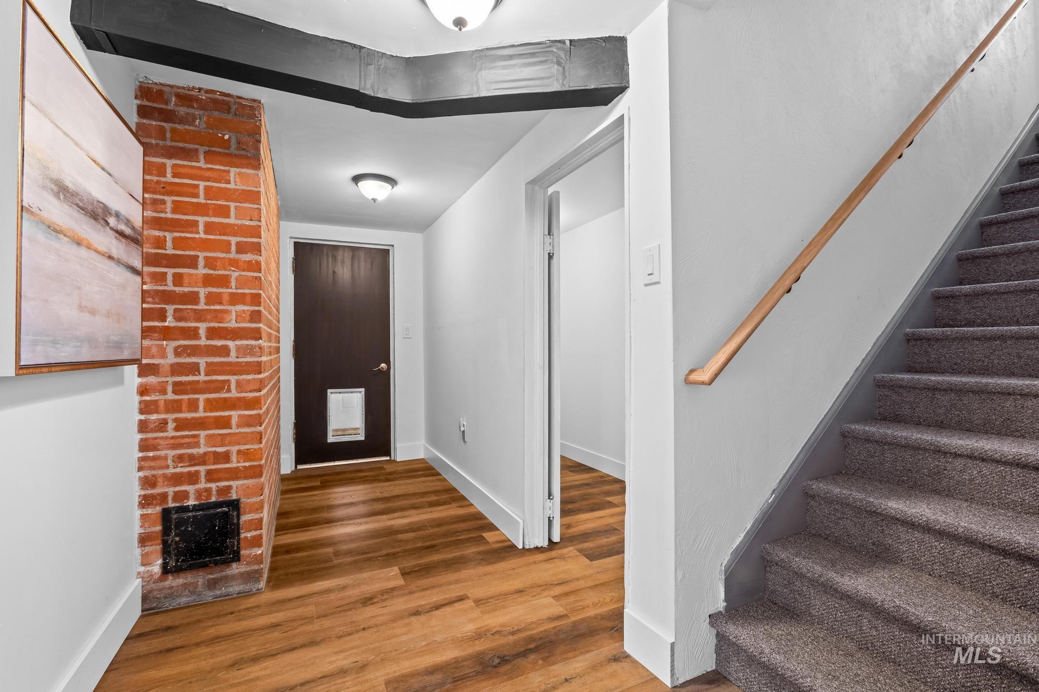 Entrance foyer featuring stairs and wood finished floors