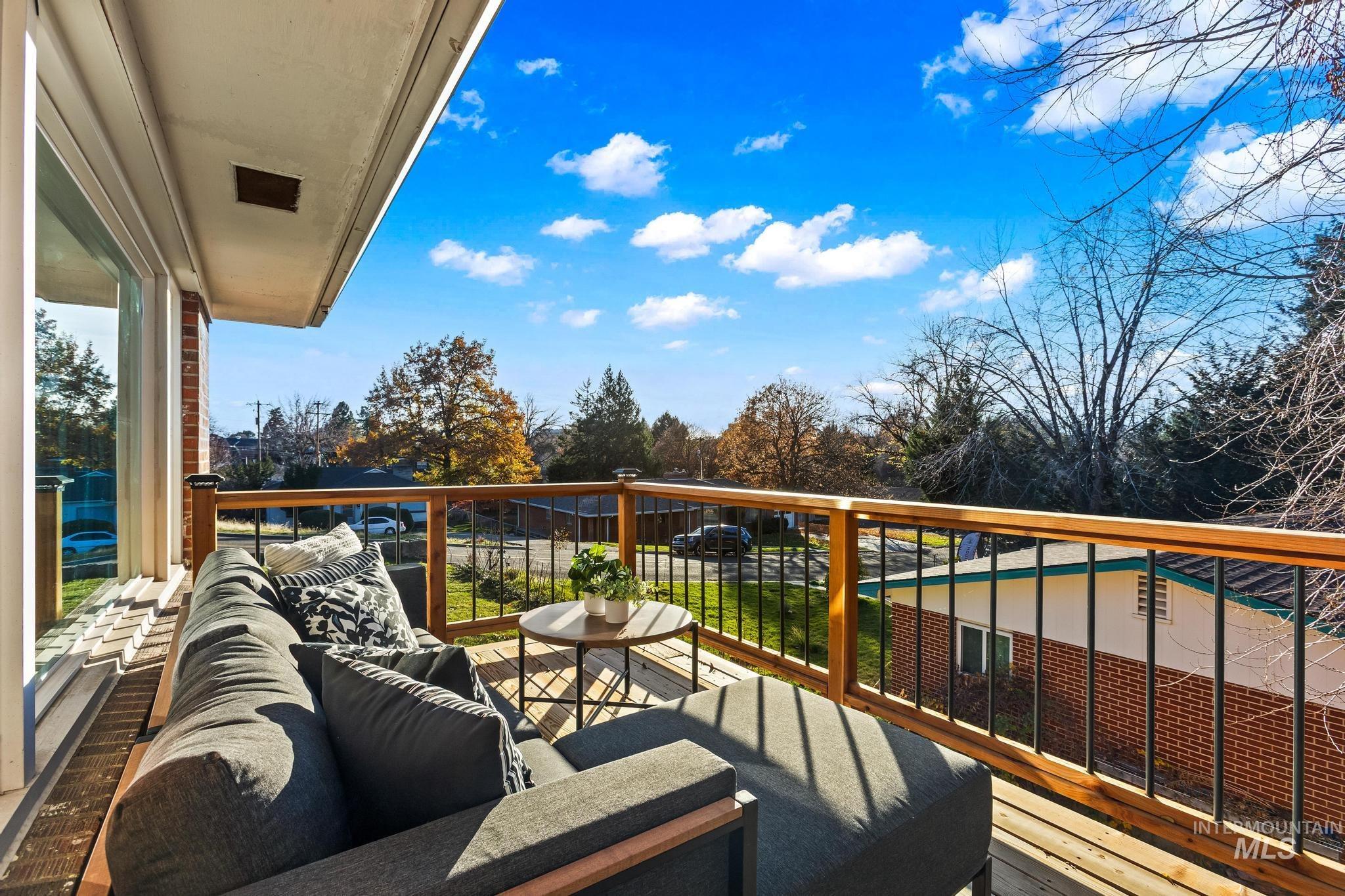 Balcony featuring an outdoor hangout area and view of scattered trees