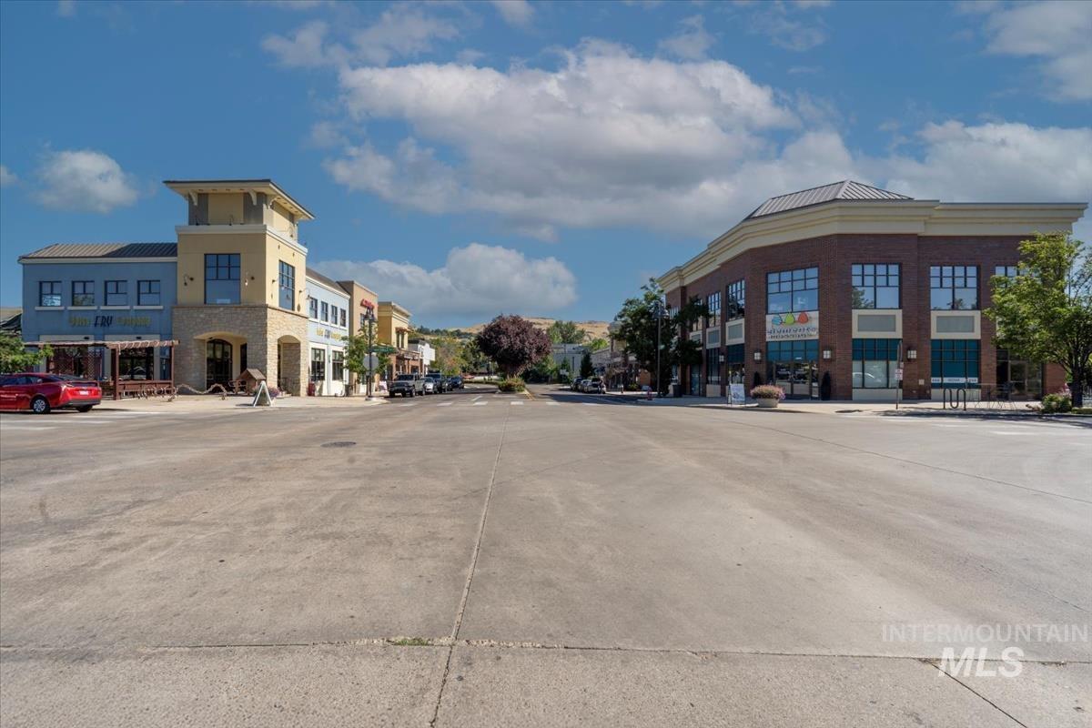 View of concrete street featuring sidewalks and curbs