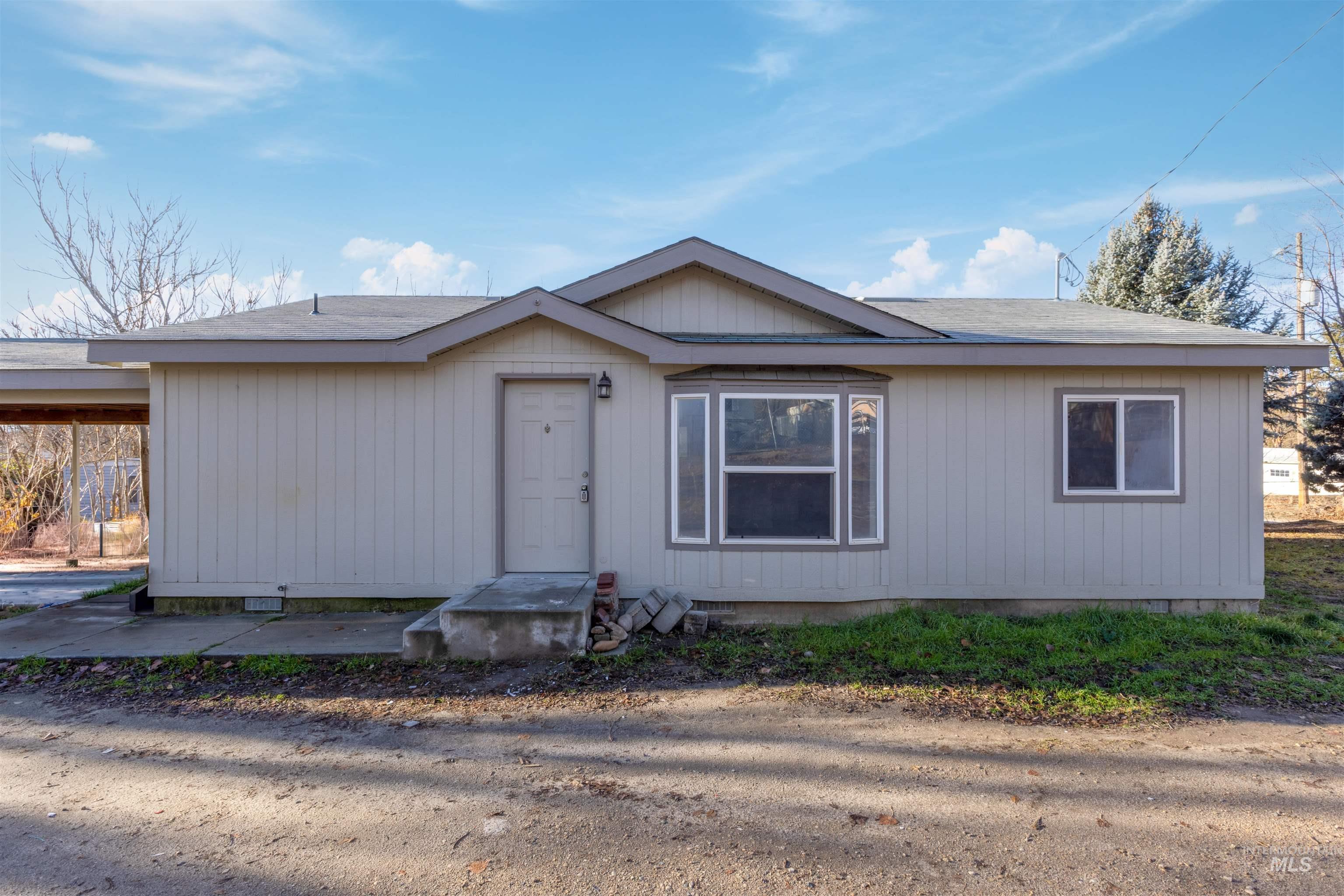 View of front of home featuring a shingled roof