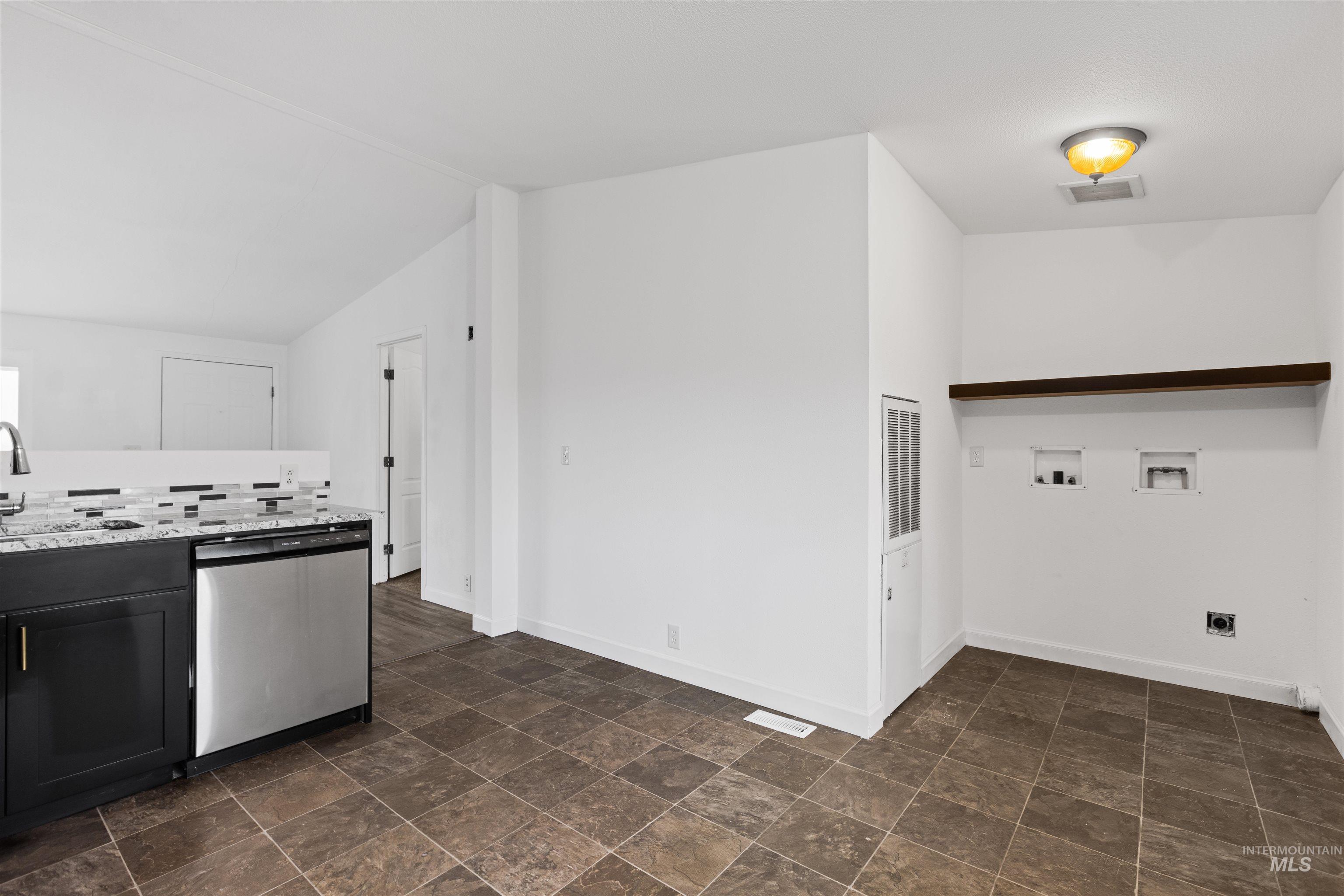 Laundry room featuring stone finish floors, washer hookup, and hookup for an electric dryer